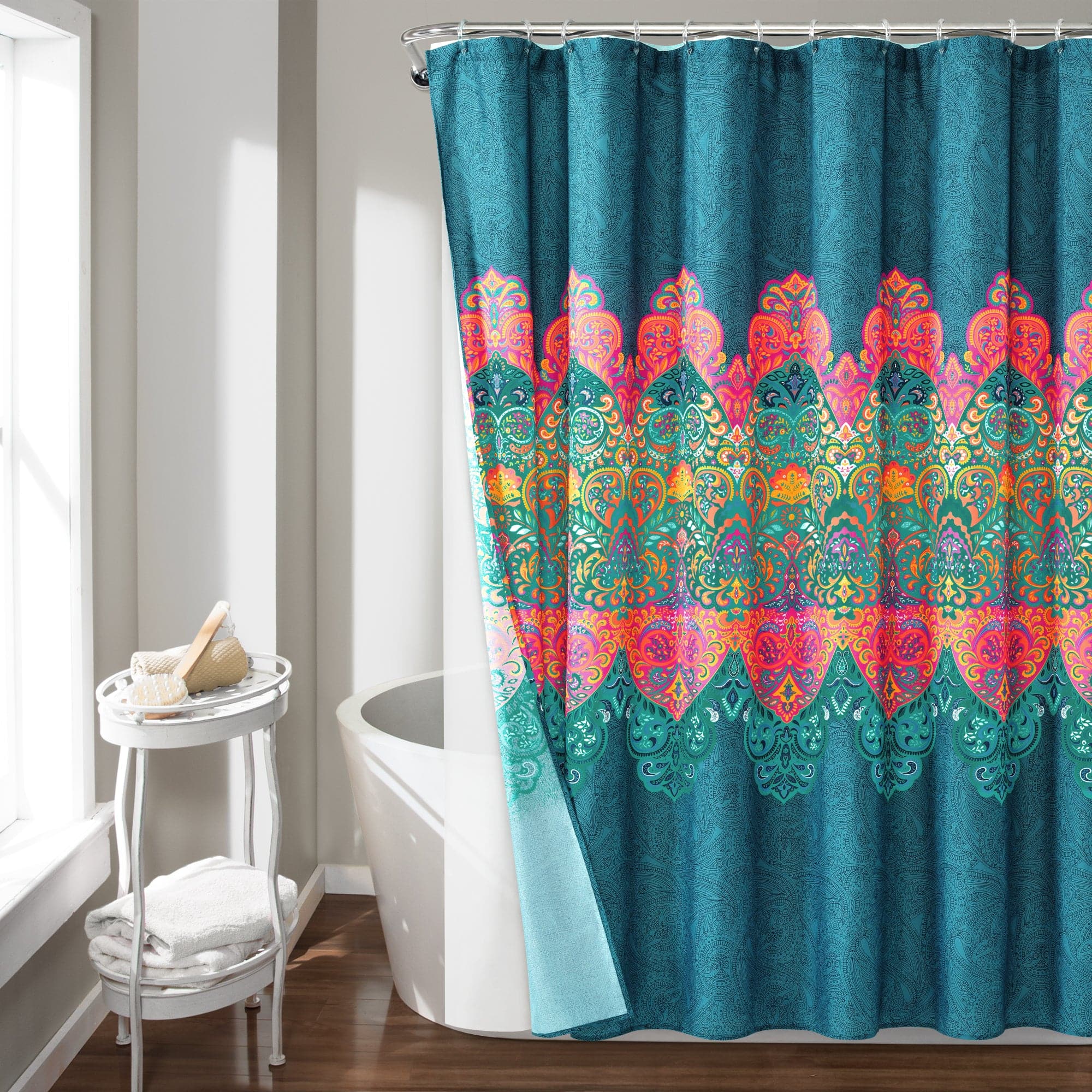 A vibrant Boho Shower Curtain with intricate multicolored patterns, featuring shades of teal, pink, orange, and green, hanging in a modern bathroom next to a white bathtub.