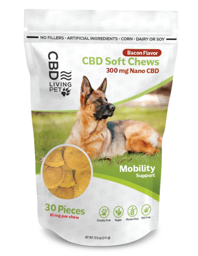 CBD Living Pet CBD Soft Chews for dogs in bacon flavor, featuring 300 mg Nano CBD for mobility support. Pack of 30 pieces with 10 mg per chew. Product highlights include no fillers, artificial ingredients, corn, dairy, or soy, and icons for cruelty-free, vegan, gluten-free, THC-free, and made in the USA. Image of a German Shepherd on the packaging.