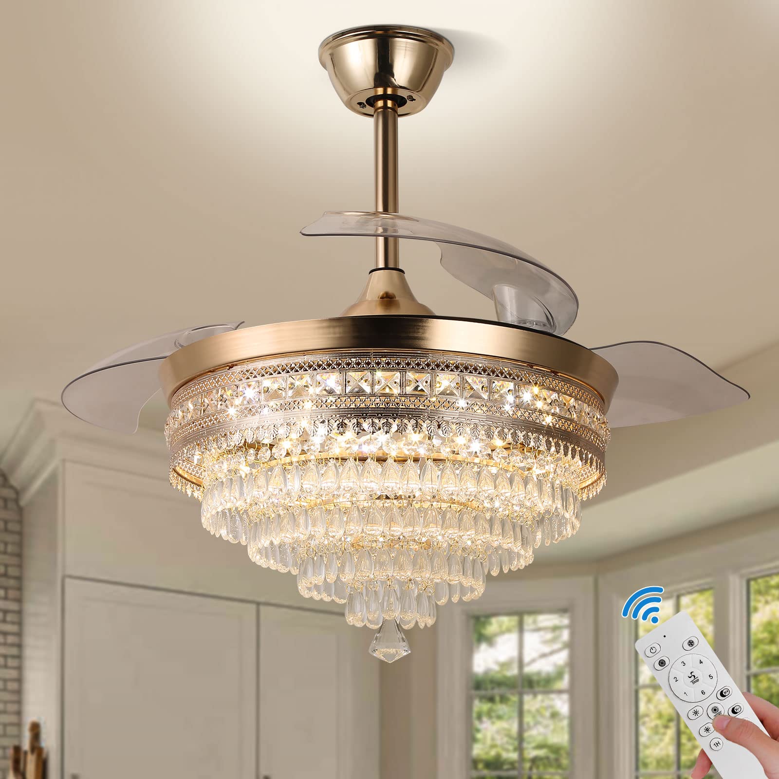 Gold crystal chandelier ceiling fan with retractable blades, shown with a remote control for operation.