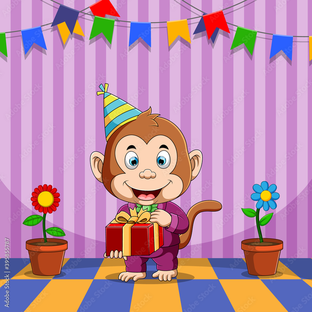 Cartoon monkey wearing a party hat and holding a gift box with a ribbon, standing on a colorful checkered floor. The background has purple stripes, hanging banners in various colors, and two potted flowers on either side.