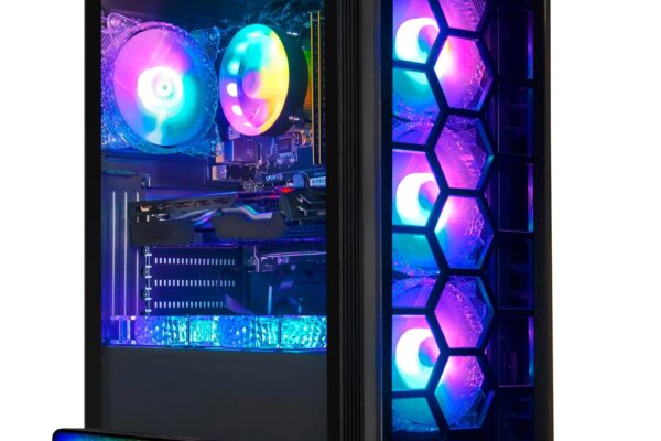 Gaming PC setup featuring a sleek black tower with hexagonal front panel design and vibrant RGB lighting illuminating internal components. Accompanied by an RGB keyboard, wrist rest, mouse, and mouse pad, all glowing with multicolored lights. Stgaubron