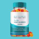 A bottle of Tetra Bliss CBD Gummies, containing 1500mg of hemp extract. The label highlights features such as 25mg per gummy, mixed assorted flavors, and advanced hemp extract. The bottle is transparent, showing colorful red, yellow, and orange gummy cubes inside, with a few gummies placed outside near the bottom. The background is a solid turquoise color.