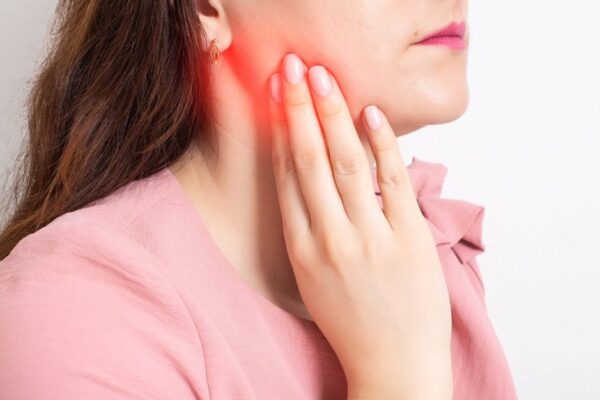 Girl touching Third Molar Pain Relief area