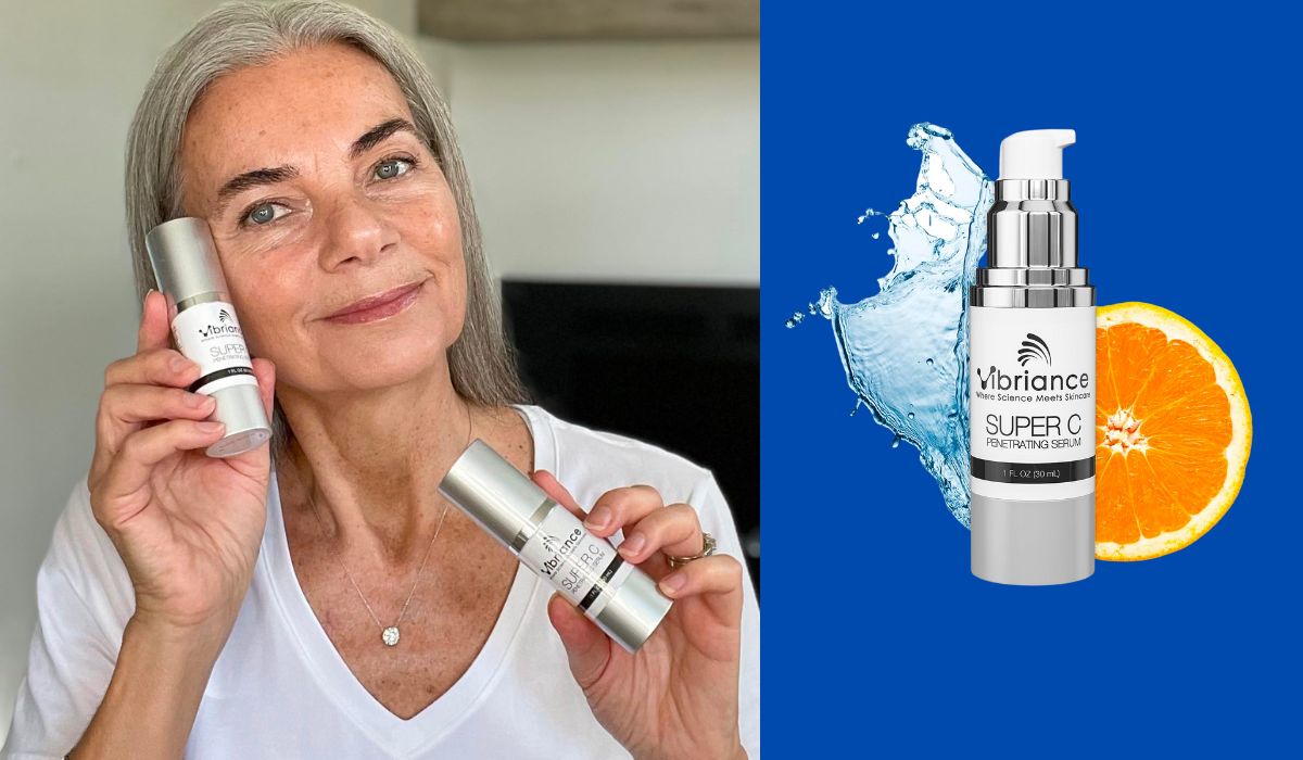 A woman with gray hair holding two bottles of Vibriance Super C Serum Penetrating Serum, smiling softly while wearing a white shirt. Next to her is a product image of the serum bottle placed against a blue background, accompanied by a splash of water and an orange slice.