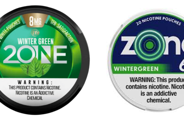 Two containers of nicotine pouches labeled 'Wintergreen.' The left container is branded '2One Zone Lawsuit' with a green and black design, 8MG strength, and an image of mint leaves. The right container is branded 'zone' with a white and blue design, 6MG strength, and a circular glowing pattern in the logo. Both containers include a nicotine addiction warning.