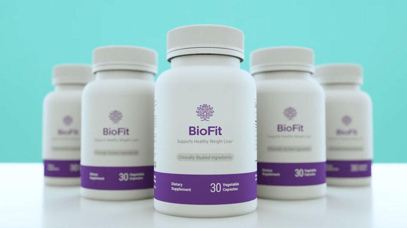 A group of BioFit Reviews dietary supplement bottles displayed against a light teal background. Each bottle contains 30 vegetable capsules and features purple and white labeling. The label states 'Supports Healthy Weight Loss*' with 'Clinically Studied Ingredients' highlighted. The product is designed to aid in weight management and overall health.