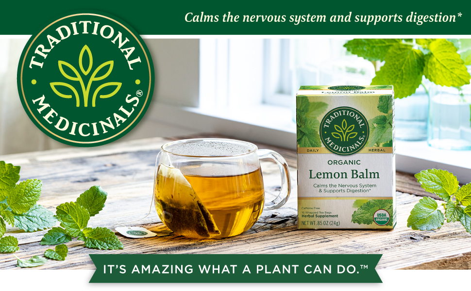 An image of a box of Traditional Medicinals Organic Lemon Balm tea on a wooden table, alongside a glass mug of brewed tea. Fresh lemon balm leaves are scattered around. The text reads, 'Calms the nervous system and supports digestion.' The tagline at the bottom says, 'It’s amazing what a plant can do.