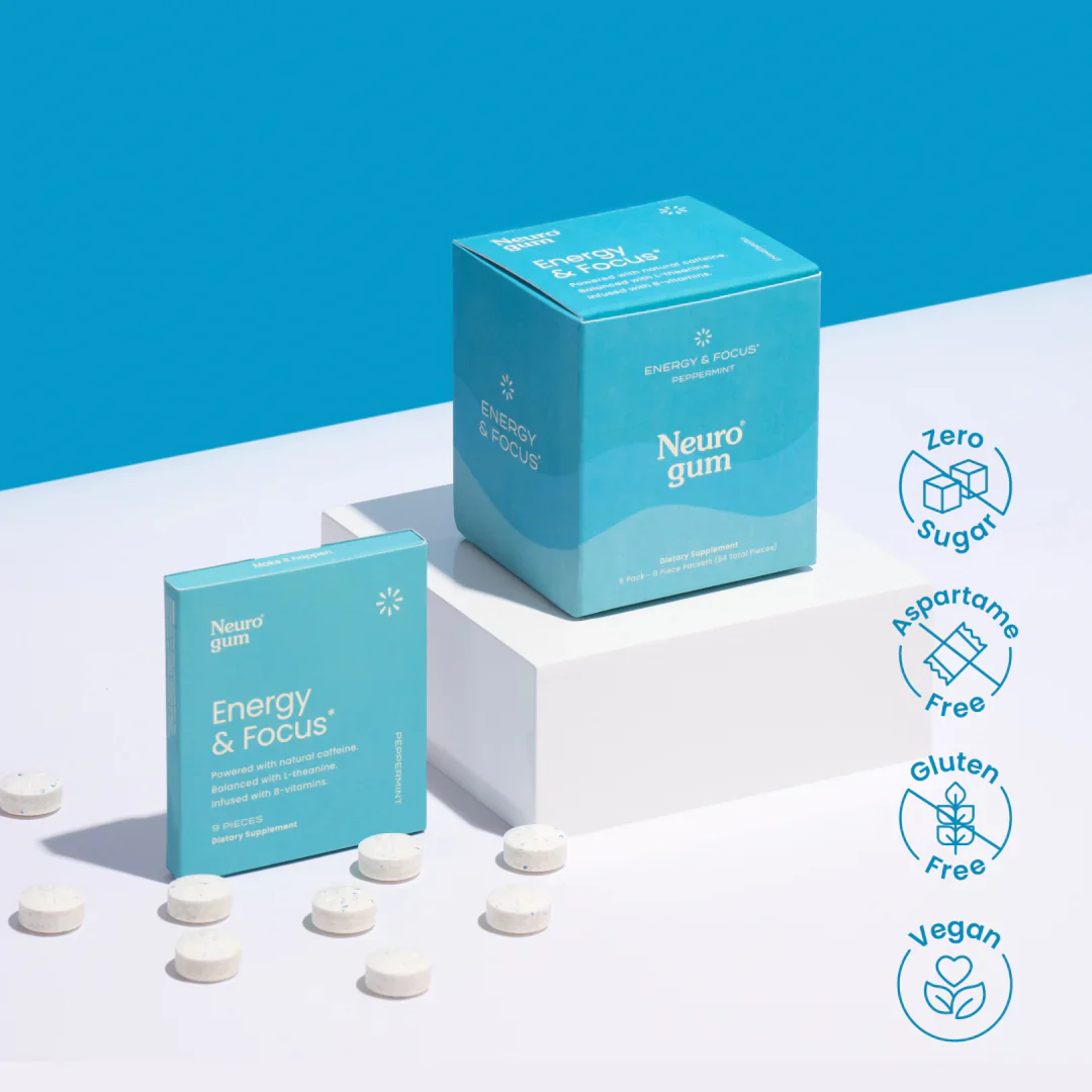 Neuro Gum's 'Energy & Focus' peppermint-flavored dietary supplement. The packaging includes a small rectangular box and a larger cube, both in blue with white text. Several gum tablets are scattered on a clean white surface. Icons on the right highlight product features: 'Zero Sugar,' 'Aspartame Free,' 'Gluten Free,' and 'Vegan.' The background is a bright blue with minimalist white platforms.