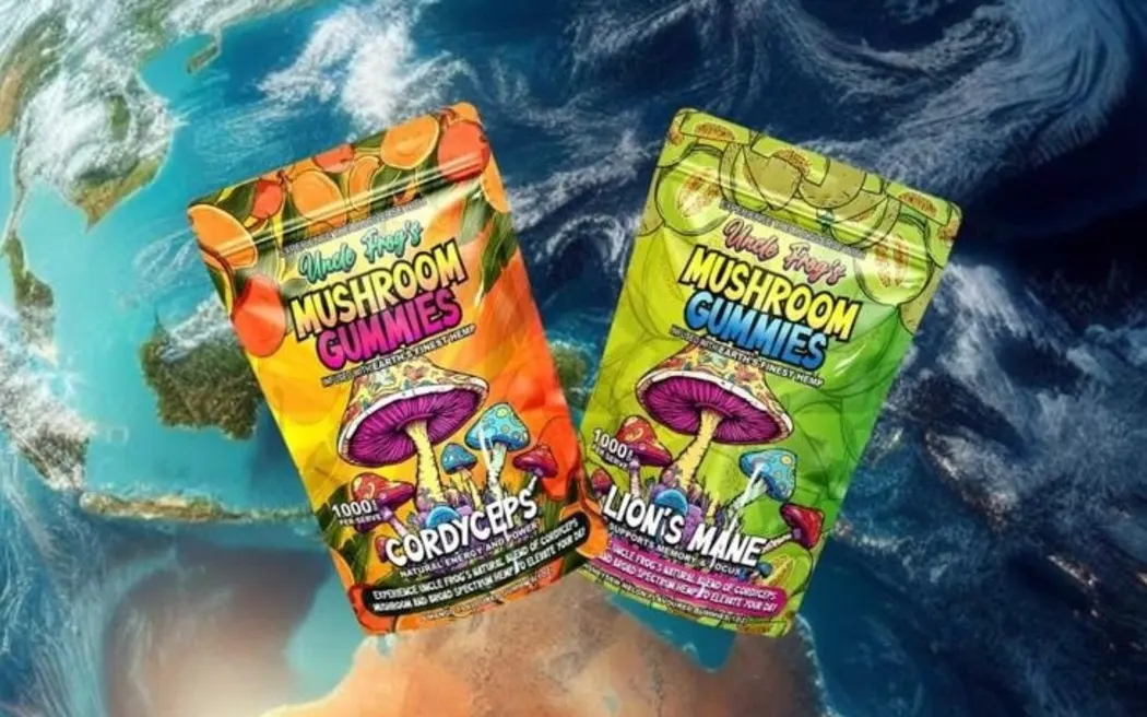 Two colorful packages of Uncle Frog's Mushroom Gummies, featuring Cordyceps and Lion's Mane flavors, displayed with a vibrant Earth background. The packaging highlights natural energy and focus benefits with bold illustrations of mushrooms.