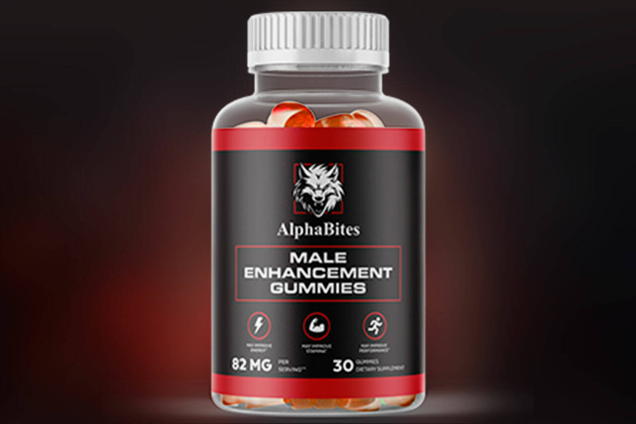 A bottle of Alpha Bites Male Enhancement Gummies with a black and red label. The label features a wolf logo and highlights benefits such as increased energy, improved stamina, and enhanced performance. The bottle contains 30 gummies with a dosage of 82 mg per serving.