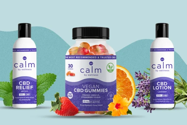 Calmwell CBD Gummies products displayed against a light blue background. The central product is a bottle of Vegan CBD Gummies, labeled as broad-spectrum hemp extract with orange hibiscus and strawberry guava flavors. To the left is a bottle of CBD Relief Menthol Gel with 150mg CBD, surrounded by mint leaves. To the right is a CBD Lotion with lavender scent and 200mg CBD, placed near lavender flowers. Fresh fruits like strawberries and oranges are also featured in the image.