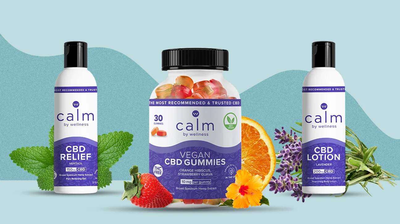 Calmwell CBD Gummies products displayed against a light blue background. The central product is a bottle of Vegan CBD Gummies, labeled as broad-spectrum hemp extract with orange hibiscus and strawberry guava flavors. To the left is a bottle of CBD Relief Menthol Gel with 150mg CBD, surrounded by mint leaves. To the right is a CBD Lotion with lavender scent and 200mg CBD, placed near lavender flowers. Fresh fruits like strawberries and oranges are also featured in the image.