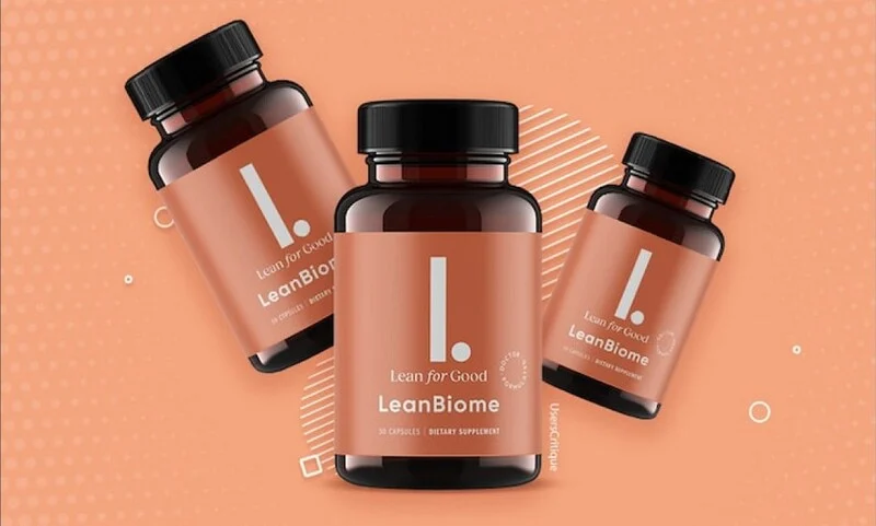 A promotional image of "LeanBiome," a dietary supplement by "Lean for Good." The image features three brown bottles with black caps, each labeled with a minimalist design, including a large white "L." on a peach-colored background. The bottles are arranged dynamically against a matching peach-toned background with abstract circular and geometric patterns. The label indicates that the product contains 30 capsules and is a dietary supplement.