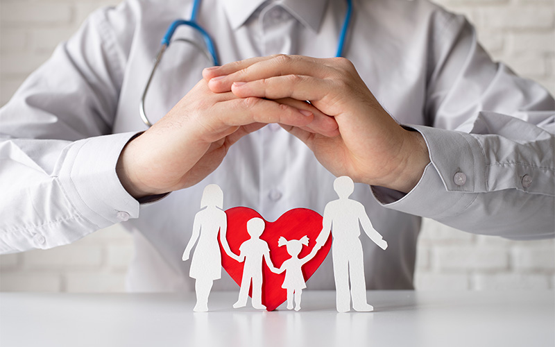Illustration of healthcare professionals reviewing public health data and research articles on HealthSciencesForum.com, a platform for health science discussions and medical insights.