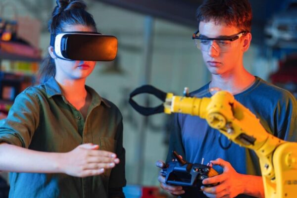 Two young engineers testing a robotic arm using VR and remote control, showcasing Rpdjafud's innovative AI and automation technology.
