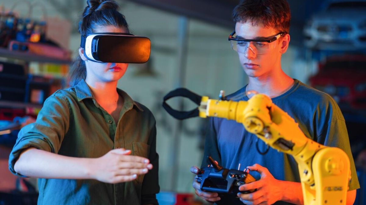 Two young engineers testing a robotic arm using VR and remote control, showcasing Rpdjafud's innovative AI and automation technology.
