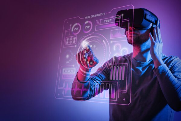 A man using a futuristic virtual reality interface with holographic controls, symbolizing Starhoonga’s innovative role in AI, immersive tech, and the future of human-computer interaction.